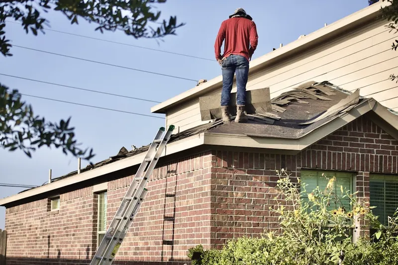 Professional roofer working on a residential roof in Ruxton